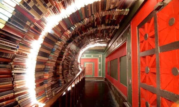 Inside The Last Bookstore in downtown Los Angeles, showing its famous tunnel made of stacked books.